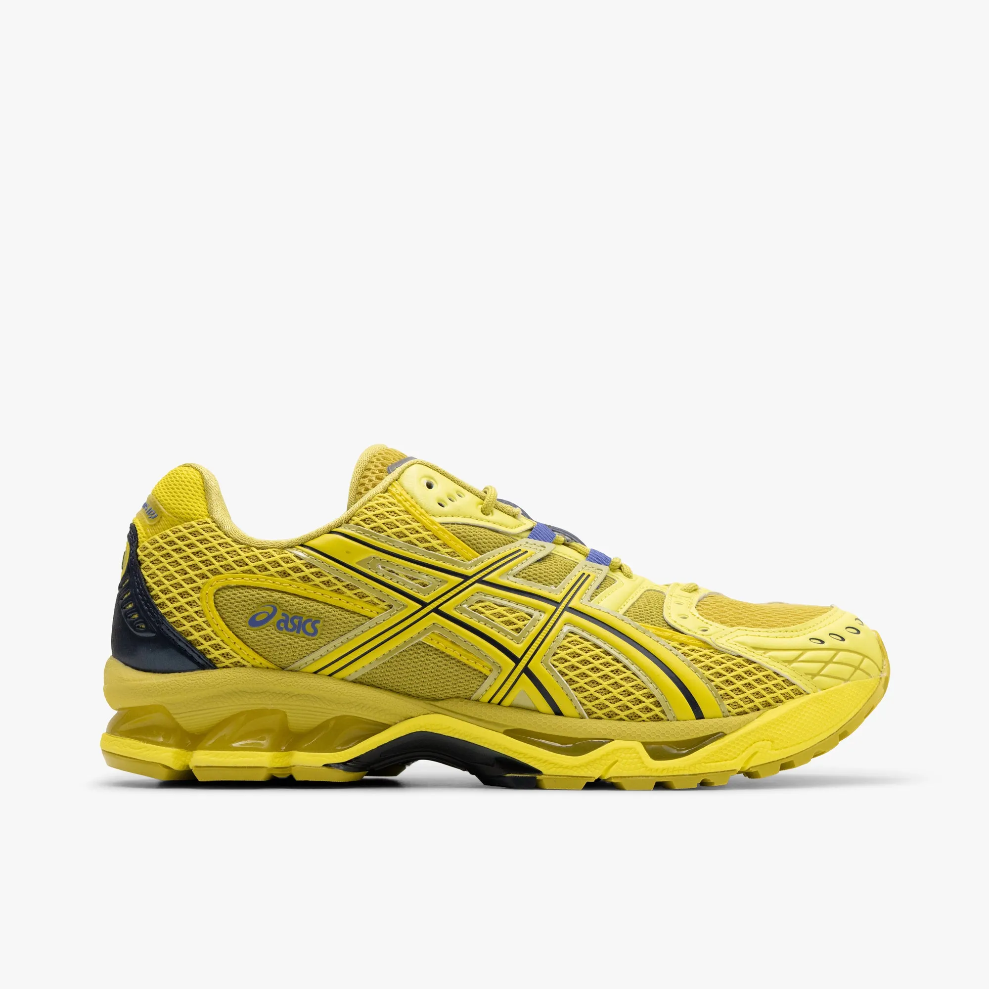 ASICS Gel-Nimbus 10.1 Kelp / Lemon Spark running in a lava field area shoes