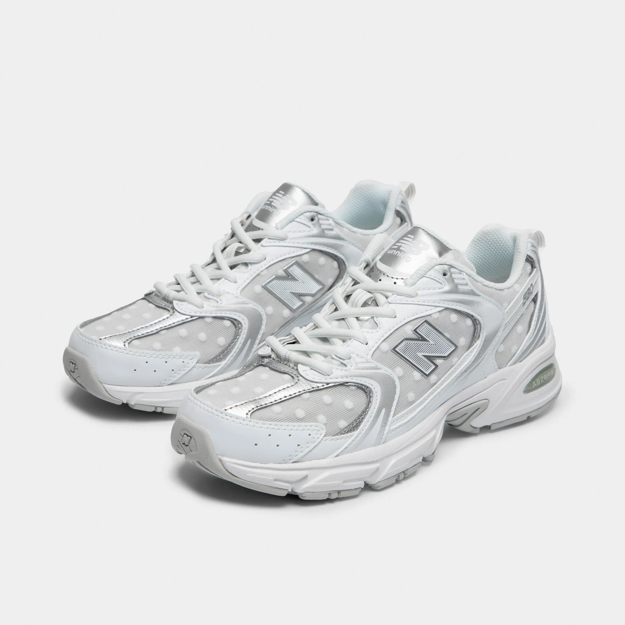 New Balance 530 White / Silver Metallic running in a sinter terrace area shoes