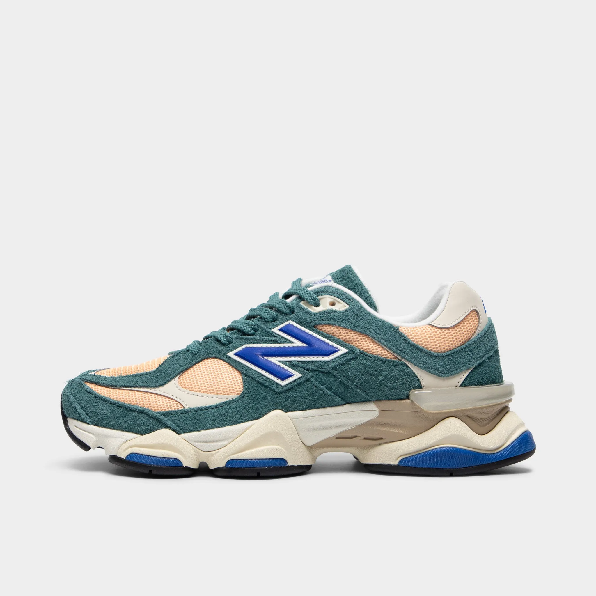 New Balance 9060 New Spruce / Peach Blossom running on a wooden track shoes