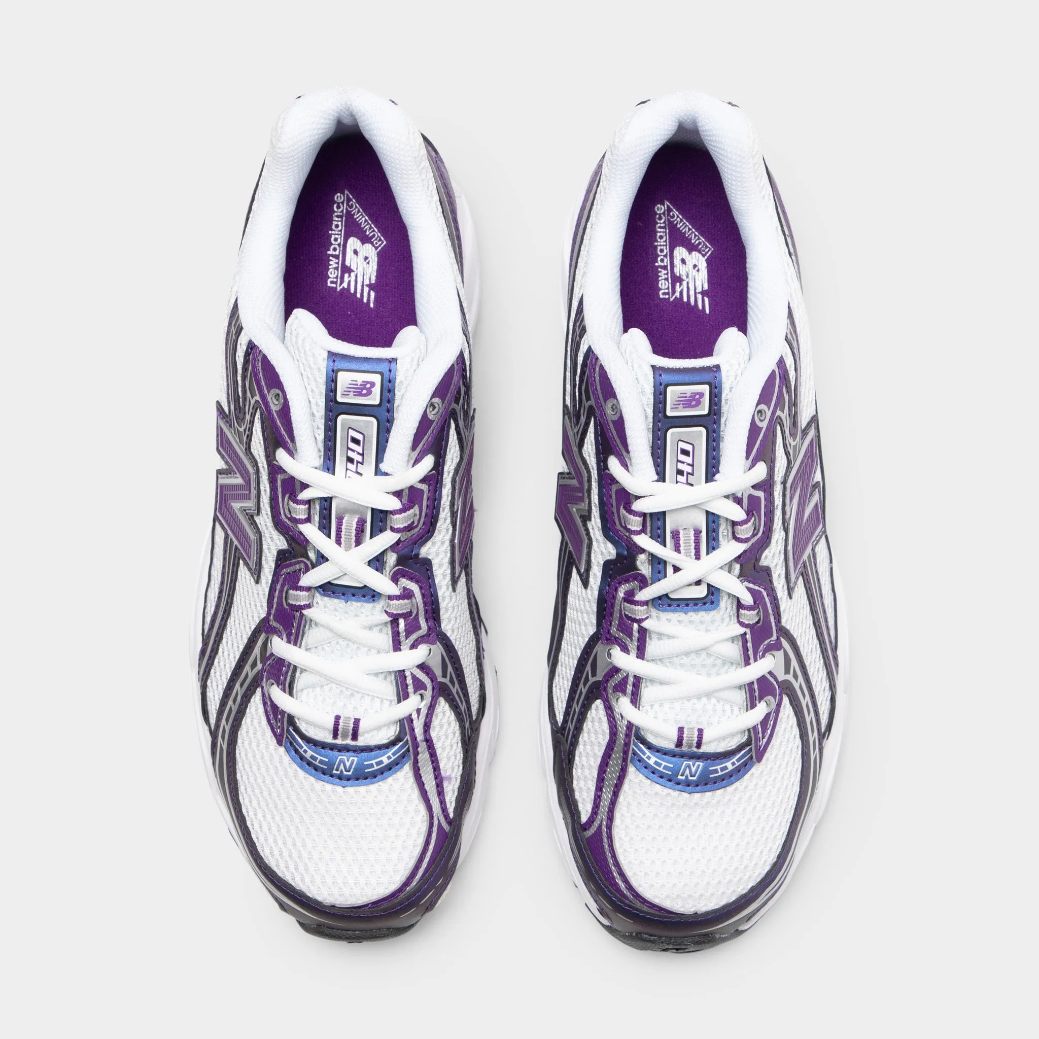 New Balance 740 White / Concord Grape running in straight tracks shoes