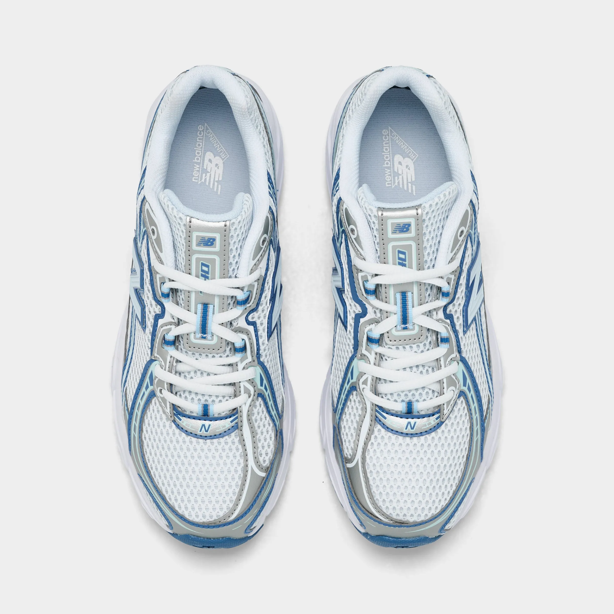 New Balance Juniors' 740 White / Blue running in a modern bridge area shoes