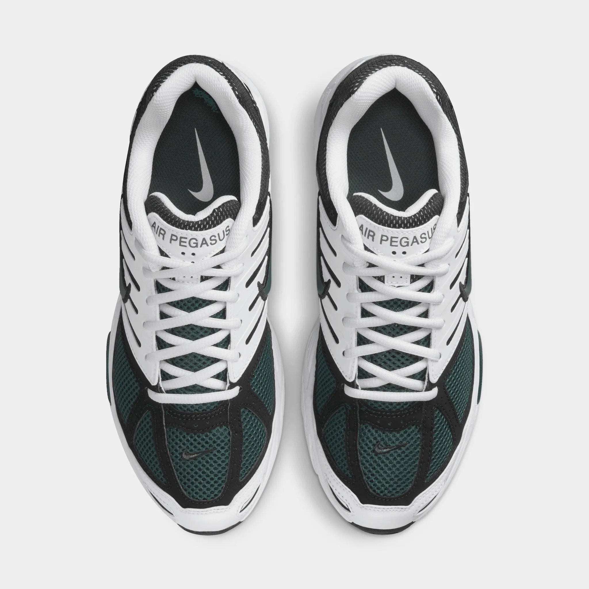 Nike Women's Air Pegasus 2005 White / Vintage Green - Black running in a monorail station area shoes