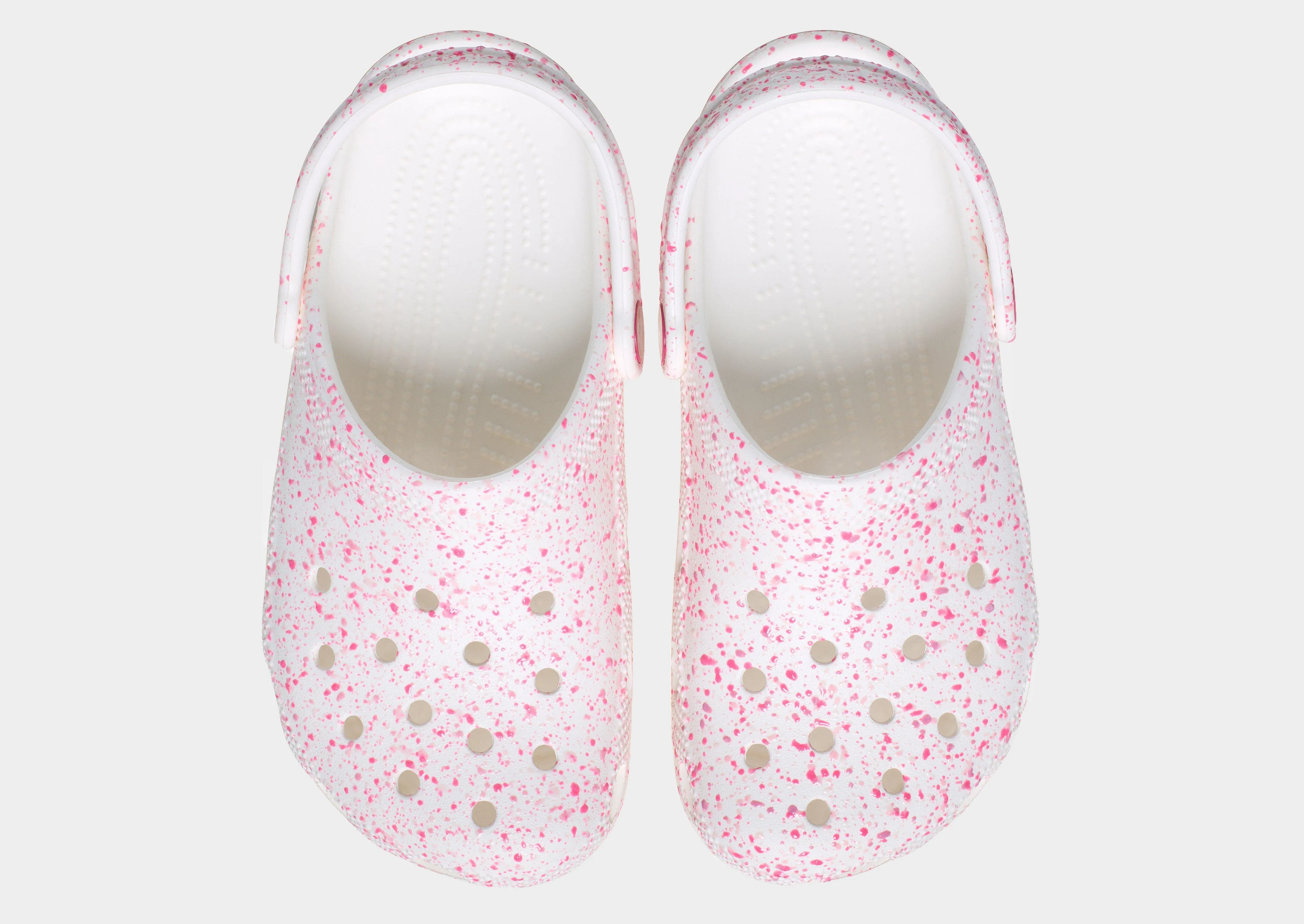 Paint Splatter Classic Clog Junior's running in a stone bridge area shoes