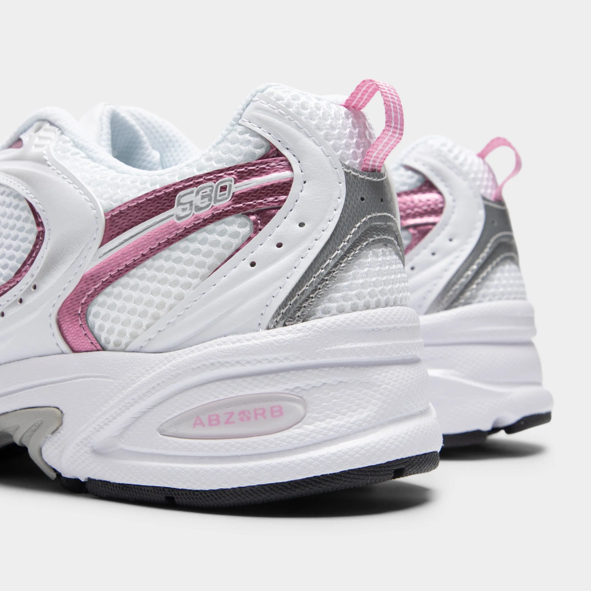 New Balance 530 White / Pink Sugar running on a gravel track shoes